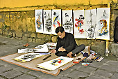 Artiste peintre de rue dans le vieux Hoi An - Viêtnam